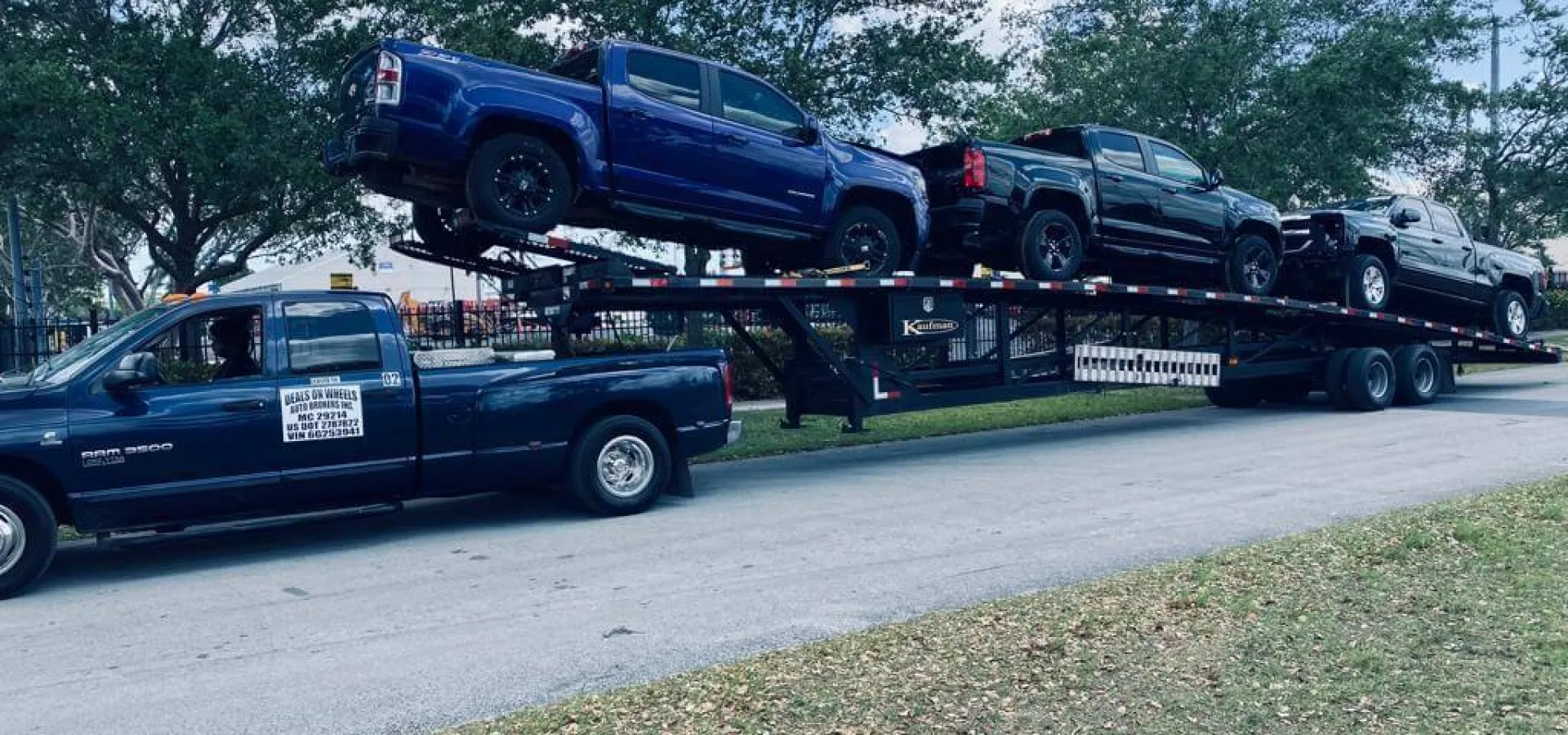 Jeep with platform carrying cars 