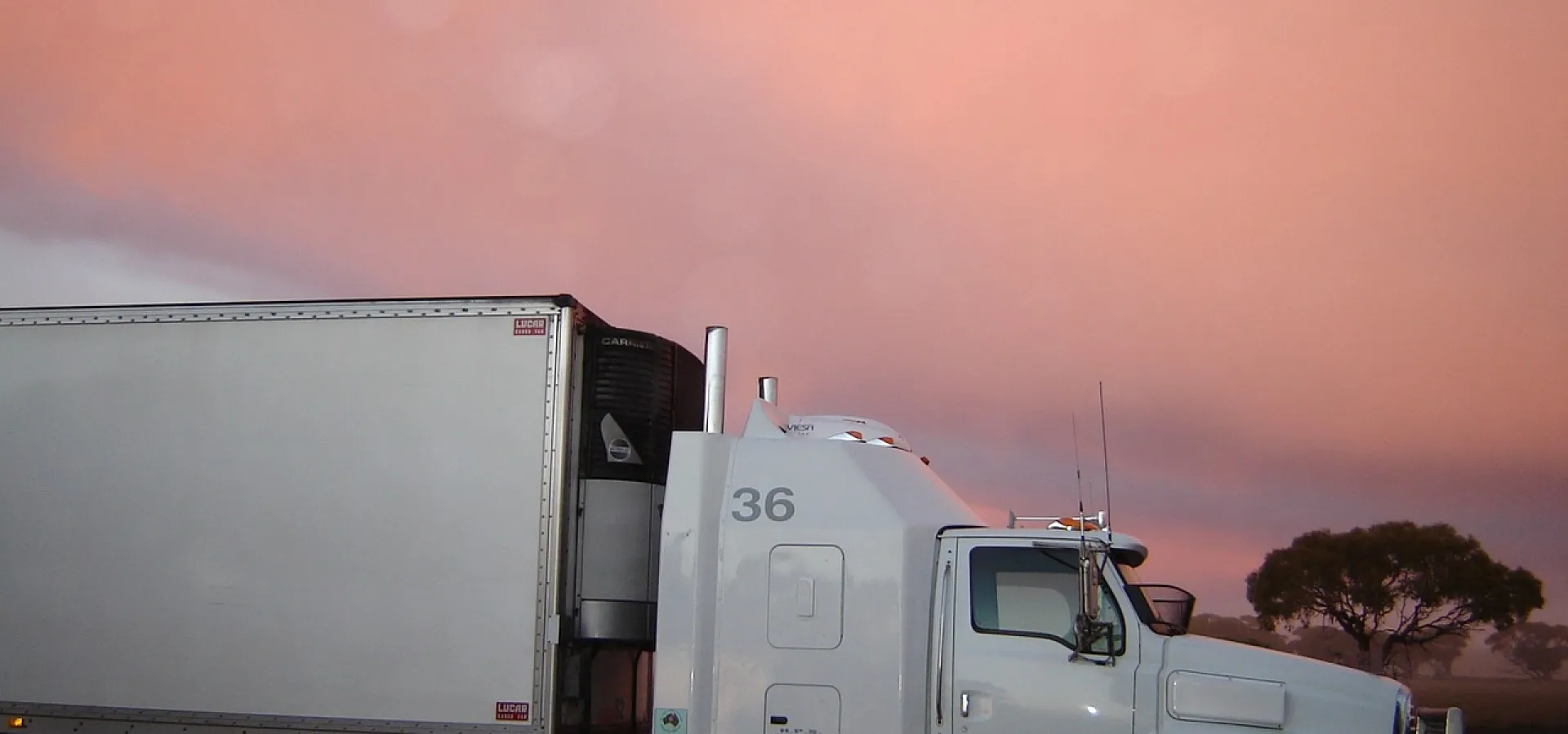 White truck behind him sunset