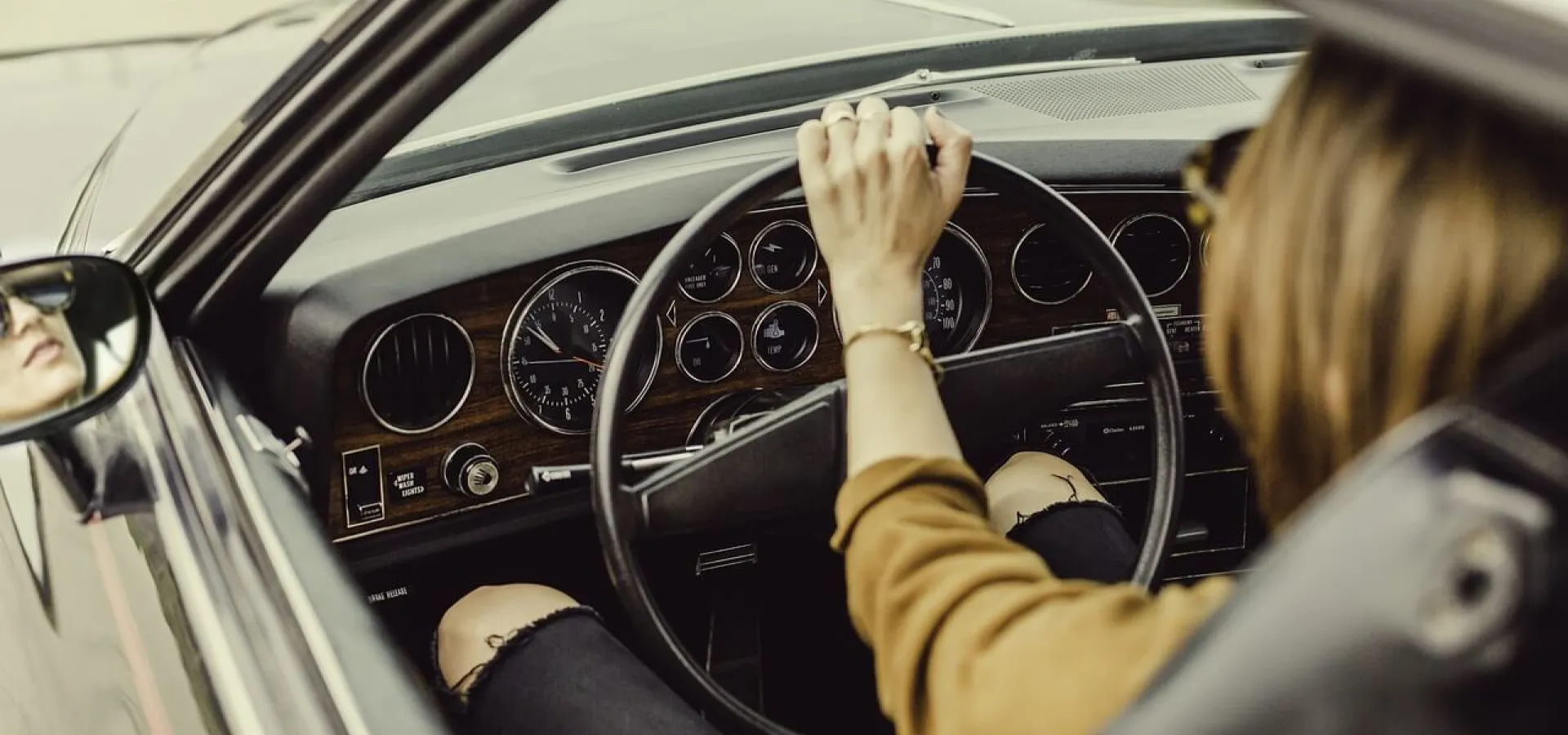 woman driving an old car