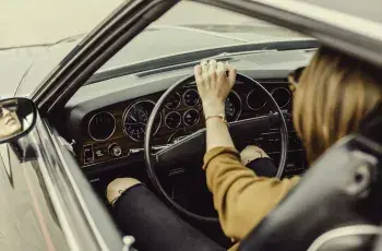 woman driving an old car