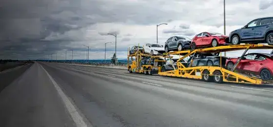 cars uploaded on an open trailer