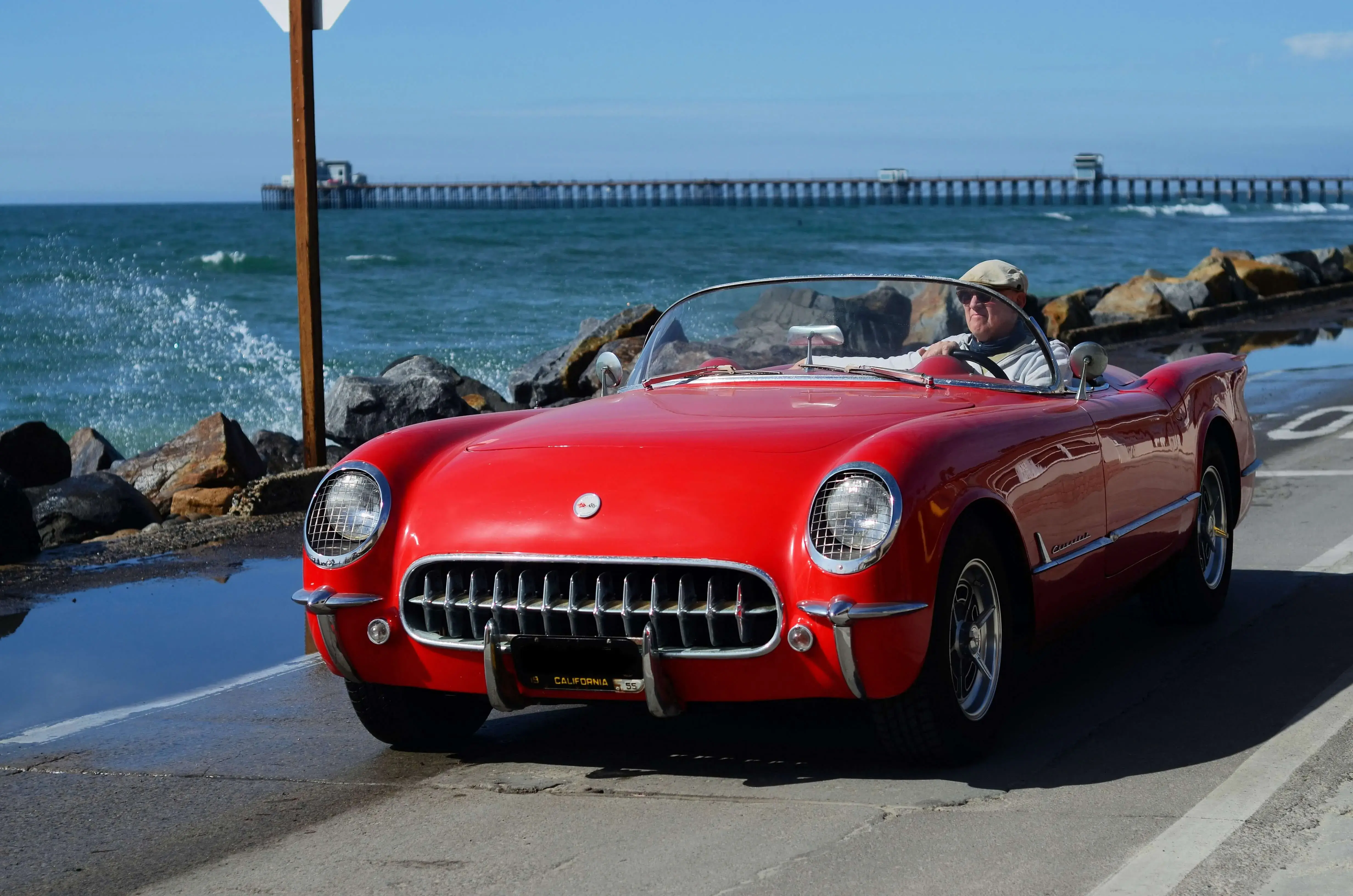 A man driving a red car A man driving a red car