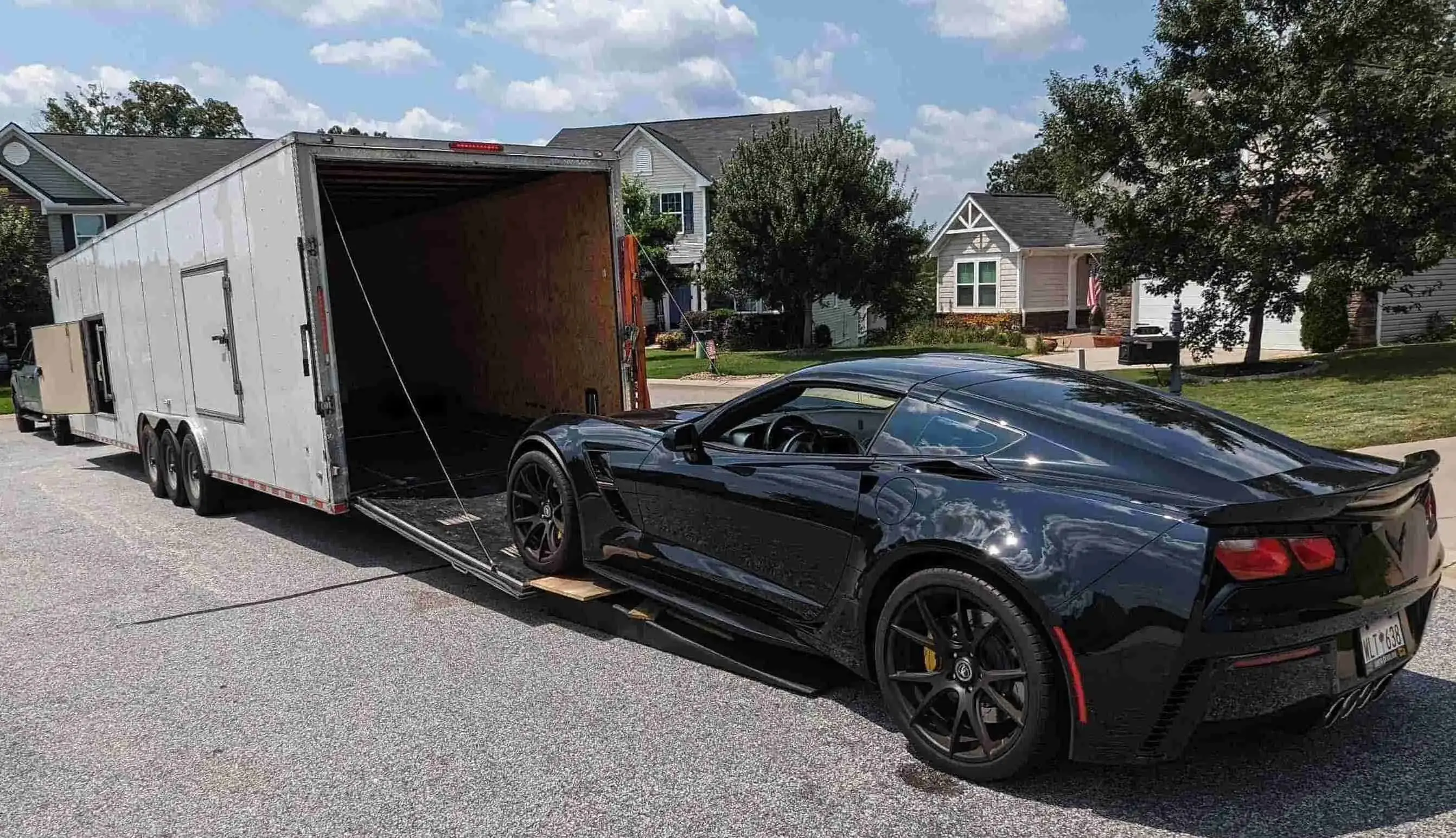black corvette uploading in an enclosed carrier black corvette uploading in an enclosed carrier