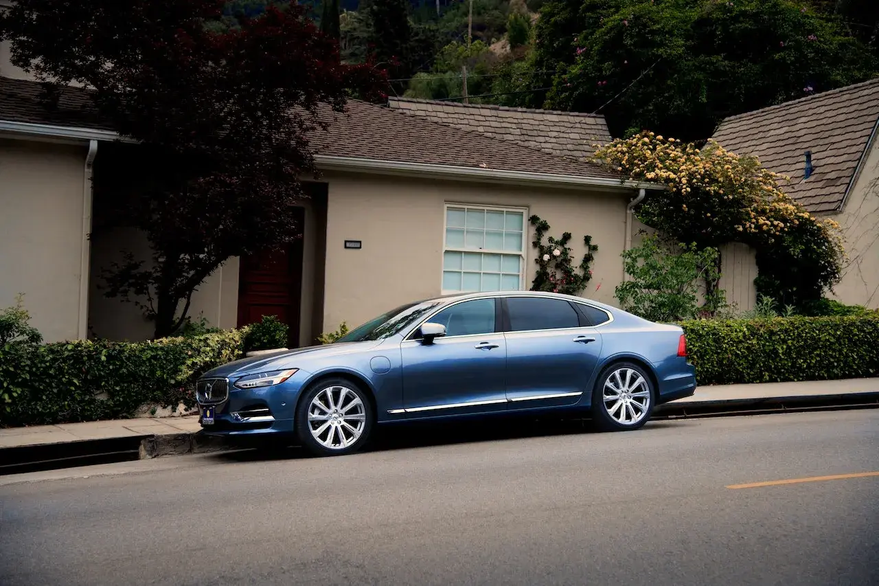 Blue Sedan parked in front of a a house Blue Sedan parked in front of a a house