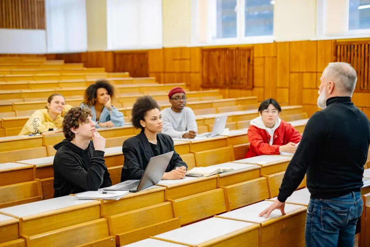 Students listening to their professor Students listening to their professor