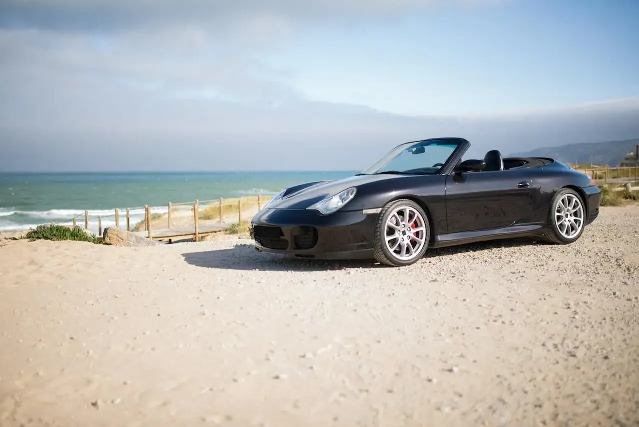 A Cabriolet Parked Near a Beach A Cabriolet Parked Near a Beach