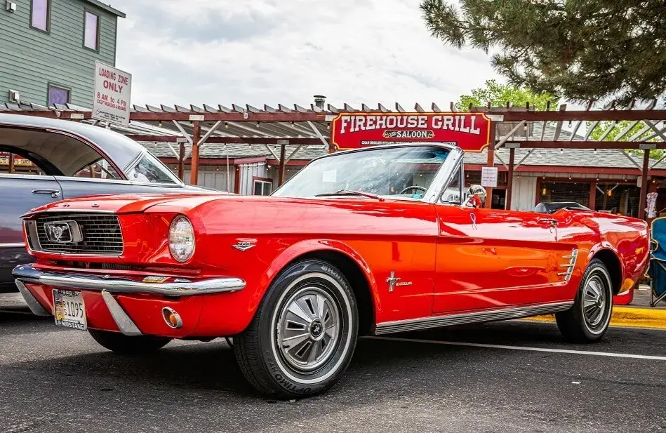 Red mustang parked in front of a grill place Red mustang parked in front of a grill place
