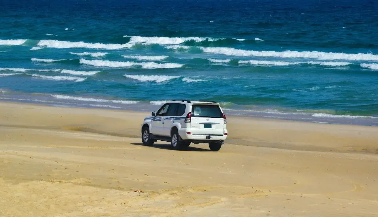 White Vehicle on Beach Sand White Vehicle on Beach Sand