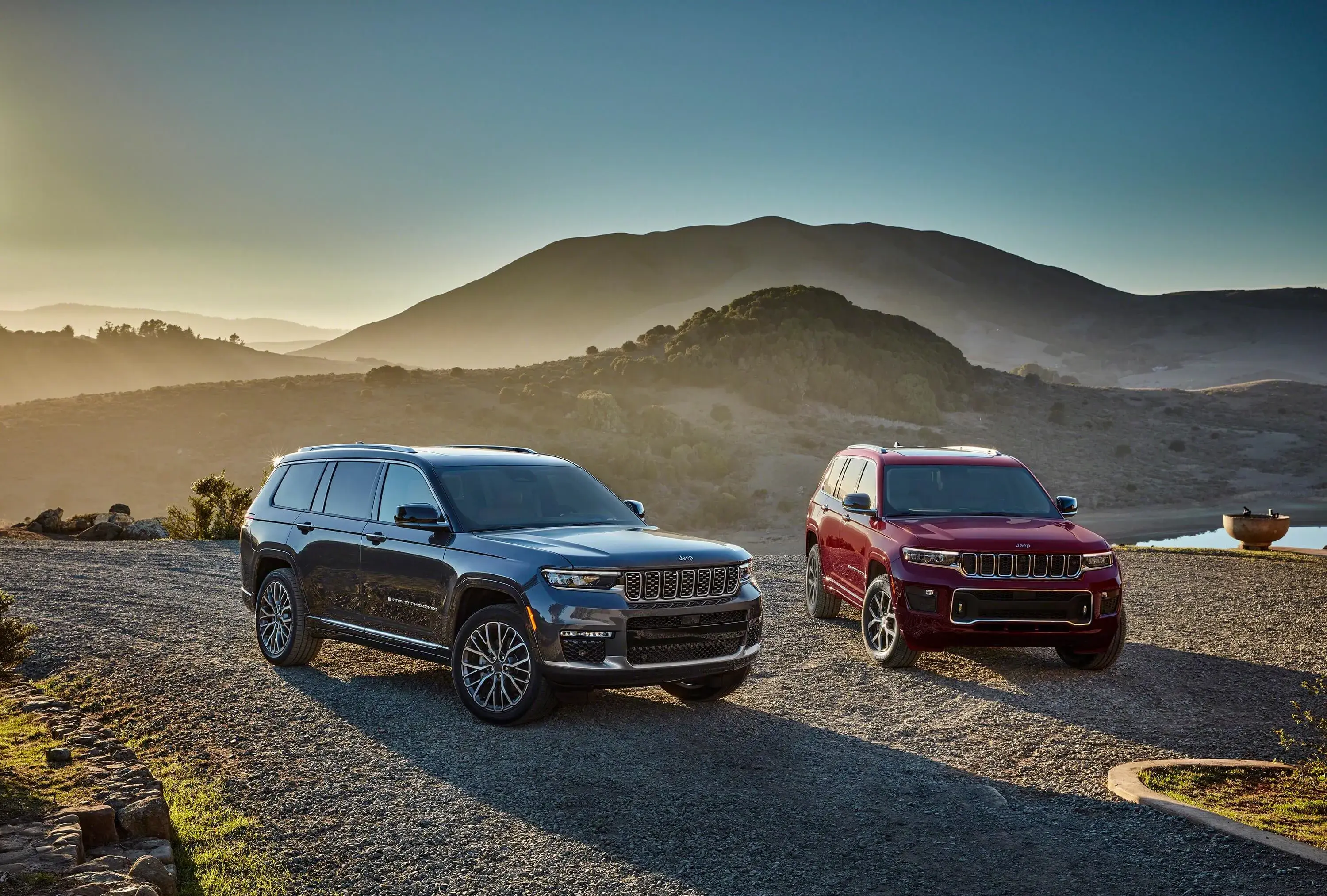 red and grey car Jeep Grand Cherokee L two cars Jeep Grand Cherokee L