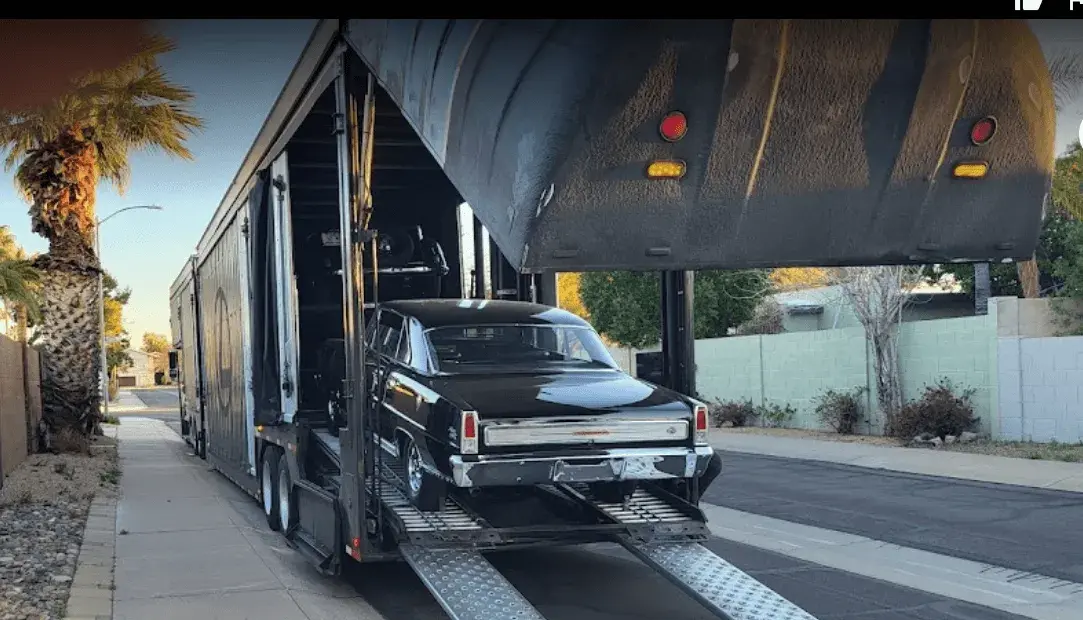 A car loading on an enclosed trailer A car loading on an enclosed trailer