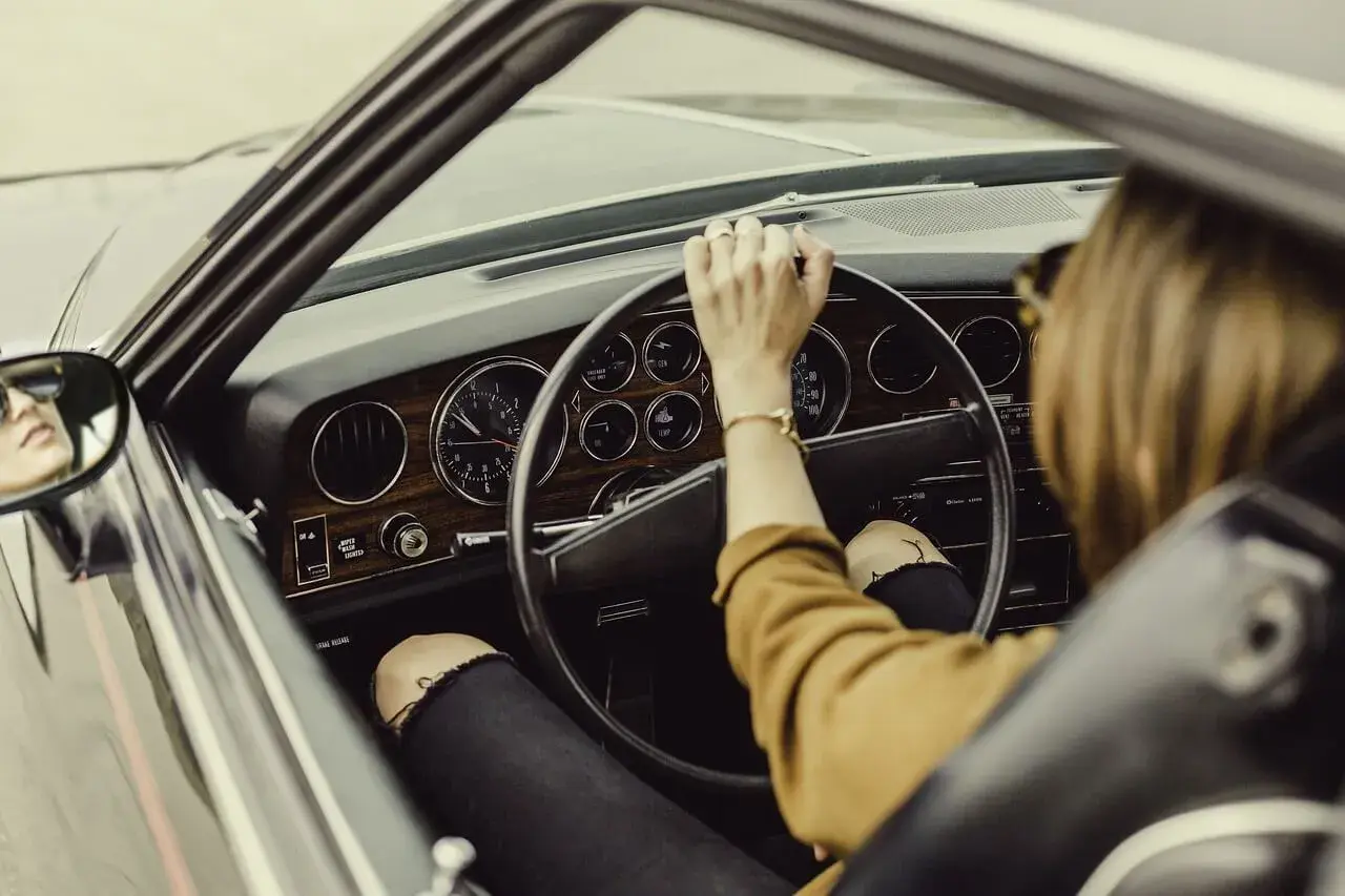 woman driving an old car woman driving an old car